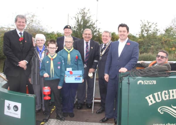 ALL ABOARD THE POPPY APPEAL! -- Scouts join officials on the Hugh Henshall narrowboat.