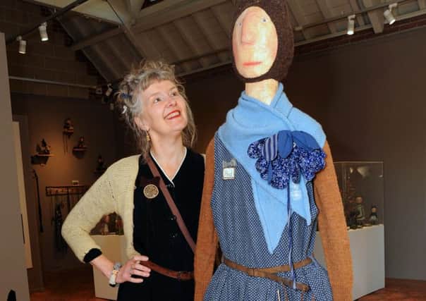 Papier mache artist Julie Arkell poses with a lifesize model of herself which accompanies an exhibition of her creations at the Harley Gallery in Welbeck