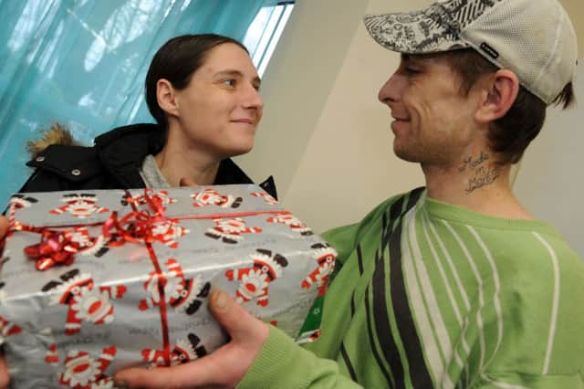 Service users, Kerriann and Dean Lewis swap shoe box gifts at Hope.