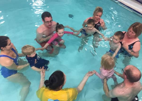 Little swimmers and their parents enjoying a class during PJ Week
