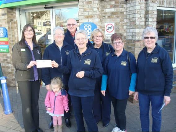 A cheque was presented by a representative from Morton Co-op for Â£1,082.32  with a few Gainsborough Heritage Centre volunteers in attendance