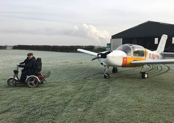 David Bell using his TGA Supersport scooter to tow one of his planes on his farm