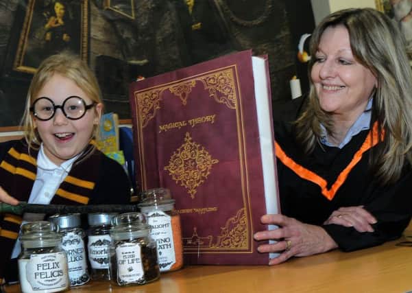 Freya Robinson casts her spells at the Gainsborough Library with cultural service advisor, Gill Blades, during Harry Potter Day.