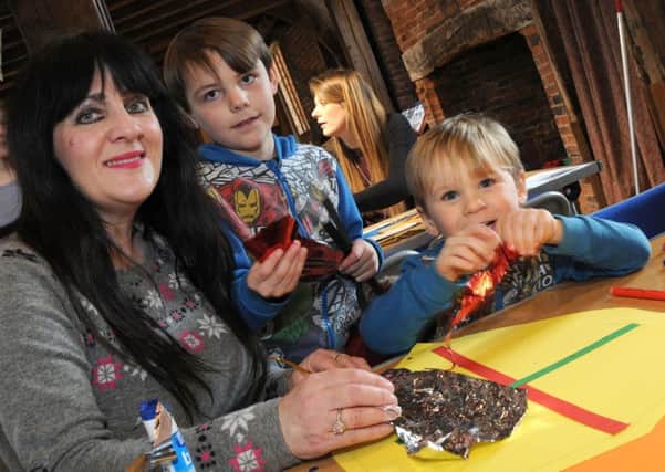 Winter Warriors craft afternoon at the Old Hall, Gainsborough.
Elijah Kirk, 7, and his little brother, Charley, 4, get some help with their designs from their Aunty Rosanna Spencer.