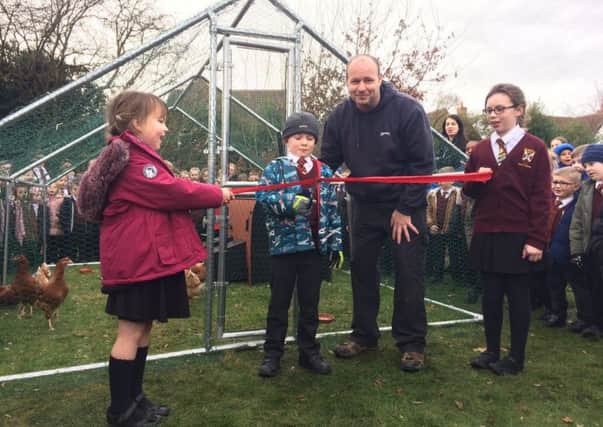 Frederick Horgan cuts the ribbon, alongside head teacher Phil Abbott,to open Worksop Priory Academy's new hen house