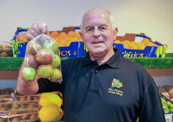 Guardian Freebie, free bag of Braeburn apples from The Priory Fruit Shop. The shop now offers a delivery service, pictured is owner steve