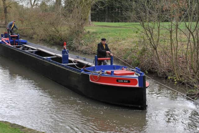 Volunteers pull barge containing new lock gates which are due to be fitted on the Chesterfield Canal near Shireoaks