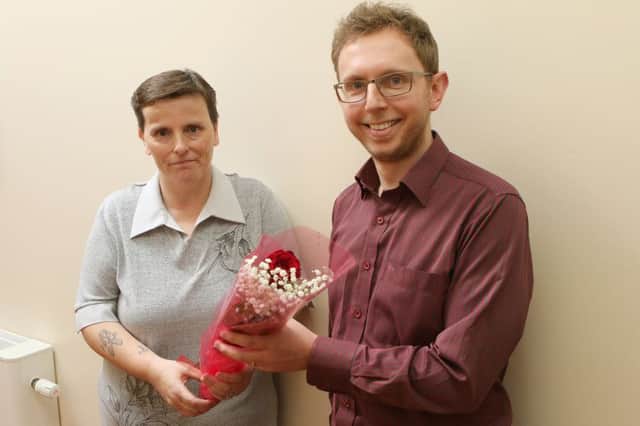 Patient Susan Pimperton presents the rose to Dr James Greenwood