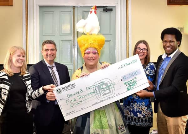 Winner Dan Baker, dressed as a panto dame, flanked by the four Bassetlaw dragons, from left, Coun Jo White, of Bassetlaw District Council, Steve Bennett, of Traffic Labour Supplies Ltd, Nicola Marshall, of Jellybean Campervans, and Ade Okubanjo, of ManKing Associates accountants. (PHOTO BY: Di Fisher)