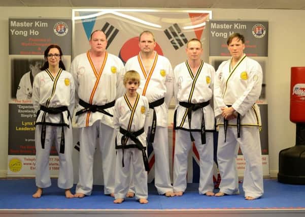 Graduates from the grading competition (from left), Donna Barker,  Michael Orchard, Dean Hobson, Paul Oakes and (front) James Oakes, with instructor Andrew Blinston (right)