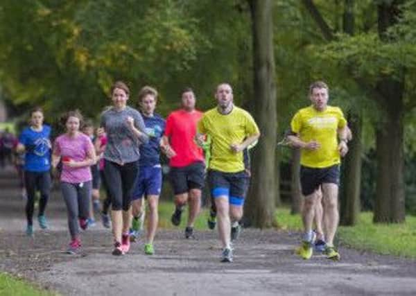 Runners on trail race in October at Gibside, Tyne & Wear. Stunning 18th-century landscape garden and haven for nature.