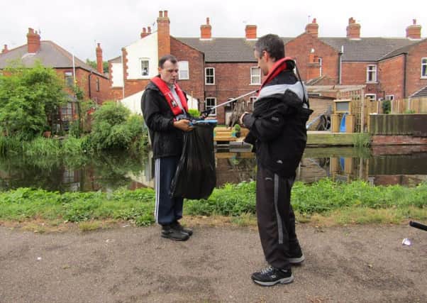 Volunteers from Autism East Midlandss Tall Trees day service in Retford help tidy up their stretch of the Chesterfield Canal