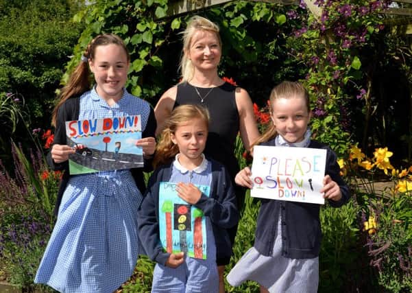 Children at St PeterÃ¢Â¬"s C of E Primary School took part in a road safety sign competition, pictured are Amy Clapperton, 11, Katy Cowland, seven and Rose Mee, eight with Coun Karen Newsome