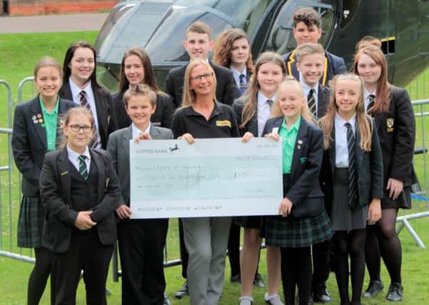 Students involved in the fundraising are pictured presenting the cheque to Karen Carter of Lincs & Notts Air Ambulance.