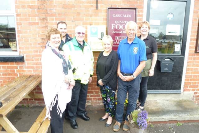 Volunteers with the new defibrillator in West Stockwith