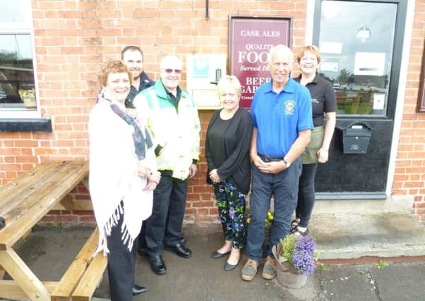 Volunteers with the new defibrillator in West Stockwith