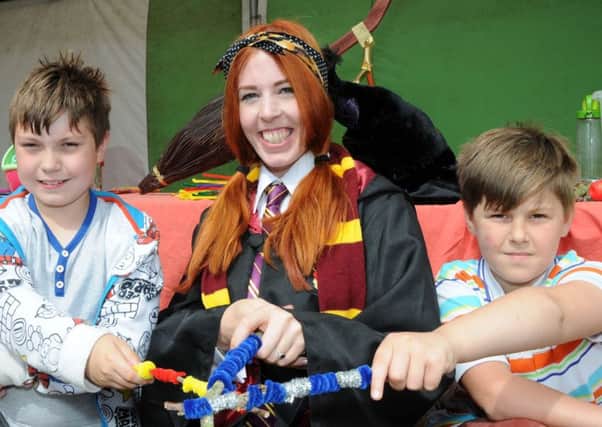 Nevan Birkitt and Malakai Morley practice their spell casting skills during a Harry Potter event at the Marshalls Yard shopping centre in Gainsborough on Friday.