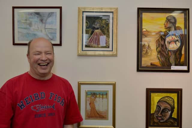 Launch of new exhibition at Worksop Library, artwork designed and produced by members of Bassetlaw MIND, pictured is Mick Allcroft with his paintings