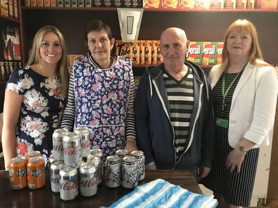 Hatzfeld Care Home Manager Jessica Poznanski with residents Julie Sekowski and David Health and Nottinghamshire County Council's Cherry Dunk behind the counter of the residents' shop in the home.