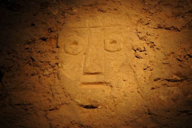 Priory Church carved face found after the removal of plaster work.
