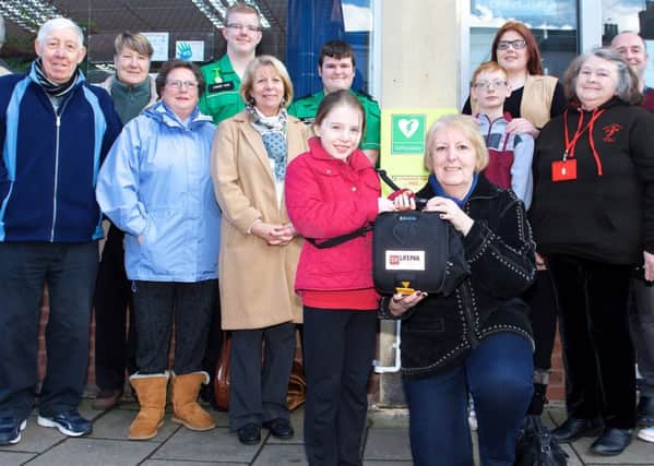 Coun Sheila Bibb with the community defibrillator installed at the Connexions Community Hub on Church Street through fundraising activities with St Johns Ambulance Gainsborough, the Performing Arts Club St Johns, National Citizens Service and the Gainsboroughs Heart Support Group