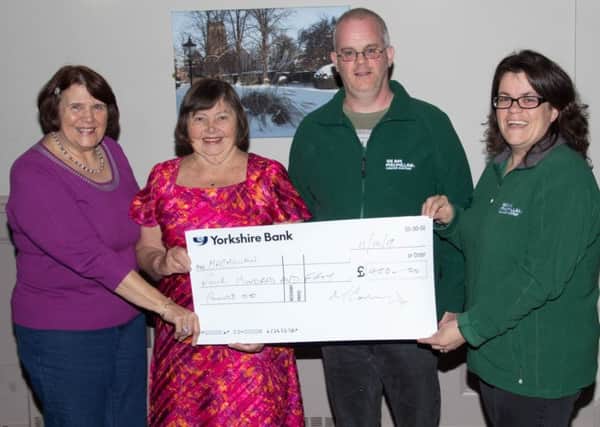 Elva Robinson and Sue Hobson, from the club, presented the cheque to representatives from Macmillan. Picture: Michael Conroy