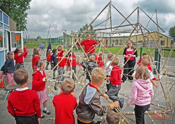 Sam McGeever, creative director at Infinite Playgrounds, encourages youngsters to develop their ideas about play equipment on an earlier project.
