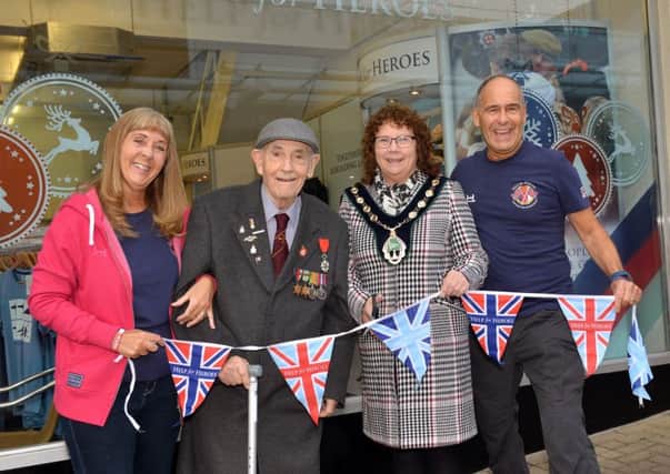 Official launch of the Help For Heroes Christina shop in the Priory Centre, Worksop. Pictured cutting the ribbon is Bassetlaw District Council Chairman Coun Madelaine Richardson with WW2 veteran Ken Beard, regional manager for Help For Heroes Tony Eaton and Julie Eaton