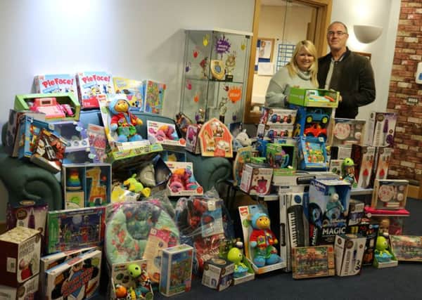 Paul and Michelle Tomkins with the treasure trove of toys for Bluebell Wood