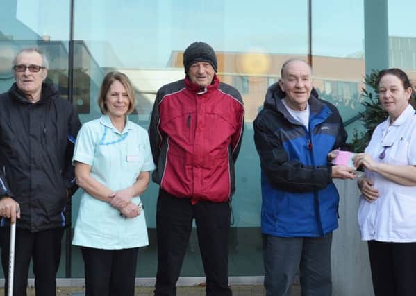 Members of the Doncaster & Bassetlaw Hospitals angling team present the cheque to staff from Ward A5