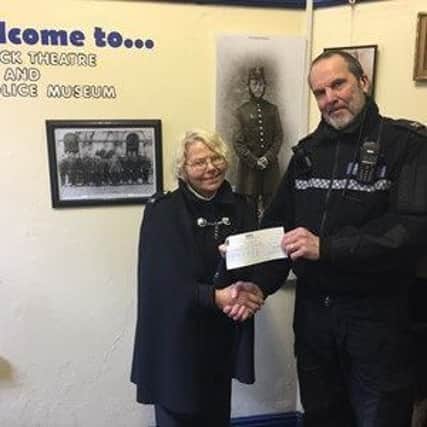 PC Ian Shaw presents a cheque to Eleanor Bowker