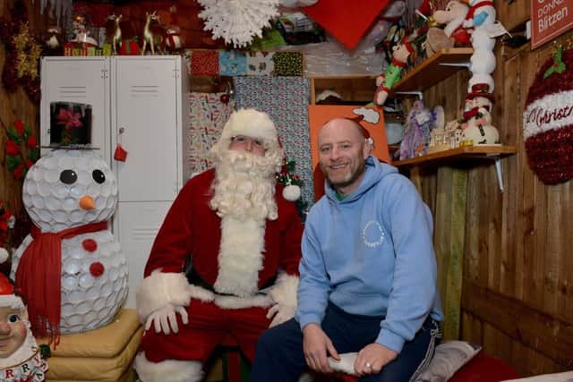 Tony McManus decorates turns his garden into a winter wonderland raising money for charity, Tony is pictured with Santa in his Grotto