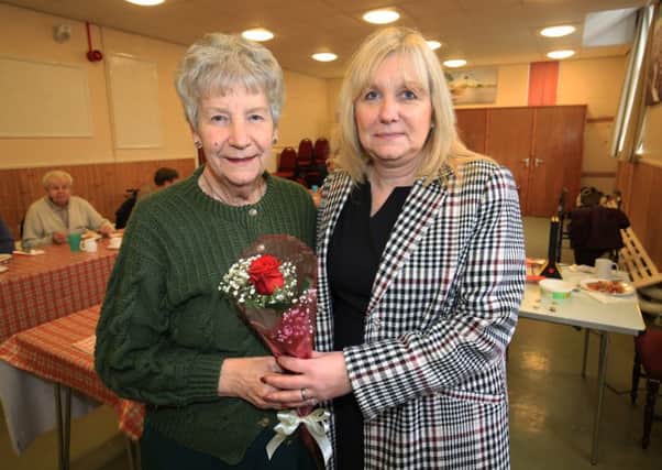 Anne Holmes is presented with The Guardian Rose after being nominated by her daughter Josie Woods for all her work serving diners at Whitwell Community Centre.  Anne is pictured with her daughter Josie.