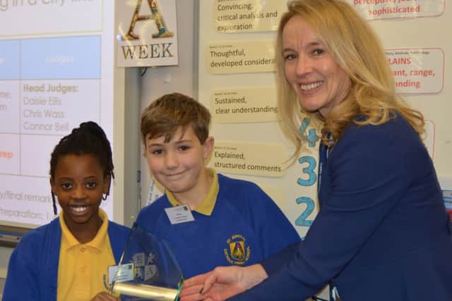 Elizabethan Academy principal Christine Horrocks presented the trophy to Anashe Rugoyi and Joshua Oprych of St Josephs Primary.