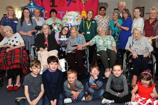 George Arnold, who had his 107th birthday at Westwood Residential Home, Worksop, on Wednesday, pictured with staff, residents and young visitors who all helped celebrate his special day.