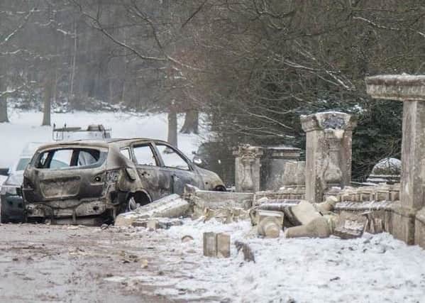 A car was used to smash the bridge's ornamental pillars and abandoned at the site.