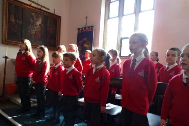 Children from Ramsden Choir perform at the ceremony.