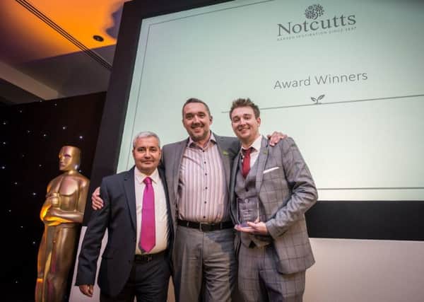 Notcutts Dukeries employee Daniel Jones (right) receives his Frontline Hero award with Notcutts operations director Chris Coward (centre) and centre manager Andrew Rawson (right).