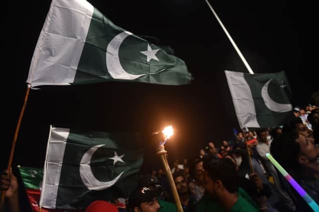 People hold national flags as they gather during Independence Day celebrations in Karachi (Getty Images)
